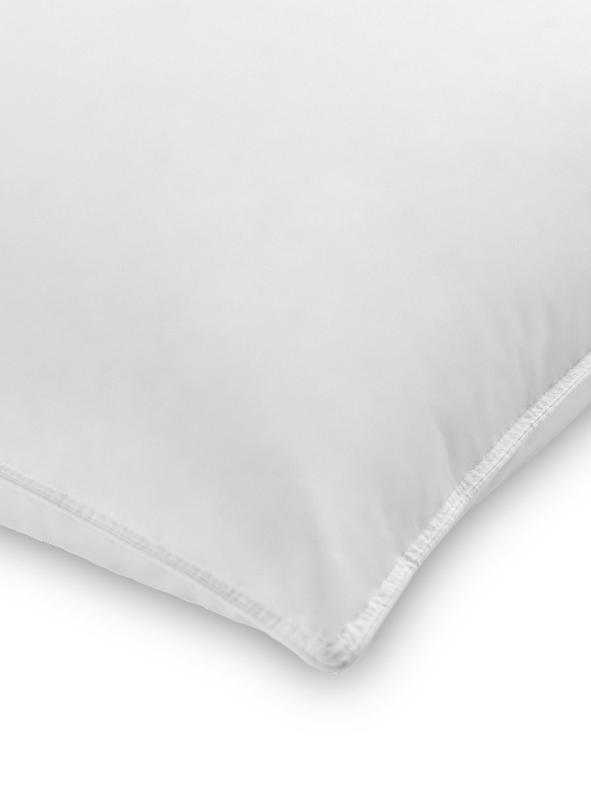 Part of a pillow with a Signature White color pillowcase featuring a thin embroidery along the edge.