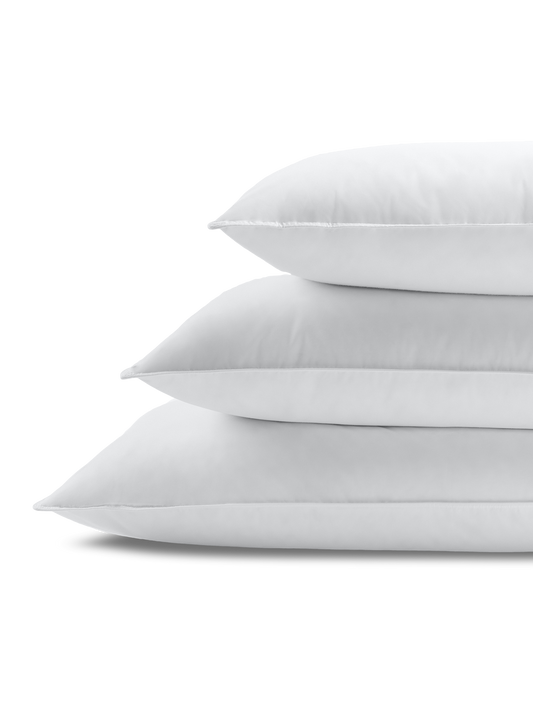 Stack of three rectangular white pillows, with visible stitching, flat, smooth, and in Signature White color.