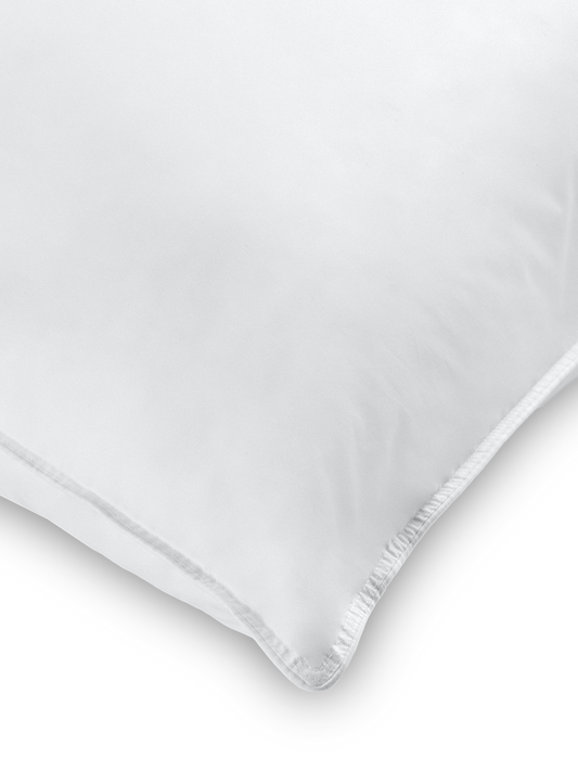 Soft, fluffy white rectangular pillow. Ideal for resting and sleeping comfortably.