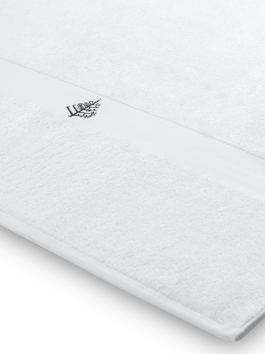 Close-up of a white Four Seasons pool towel with an embroidered Four Seasons logo.