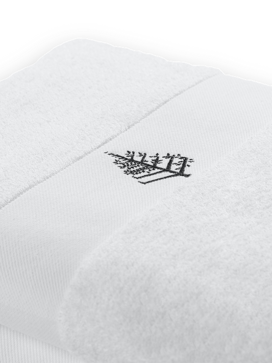 Front fold of a white pool towel with embroidered Four Seasons logo.