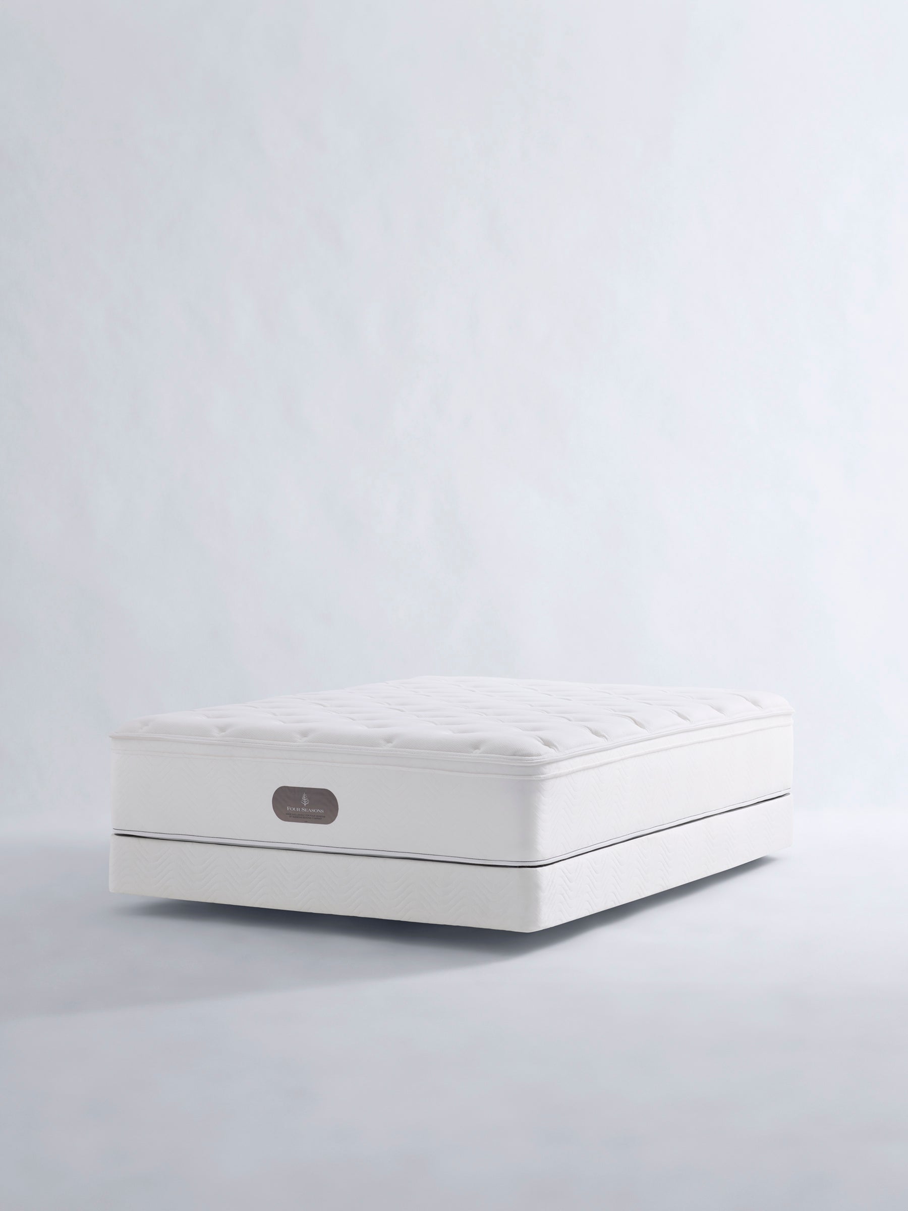 luxury mattress with a quilted surface. The Four Seasons logo is visible.