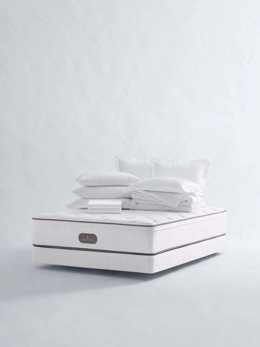 Four Seasons Bedding Set. The set includes a white mattress, a white comforter, and several white pillows, all neatly arranged on a white background.