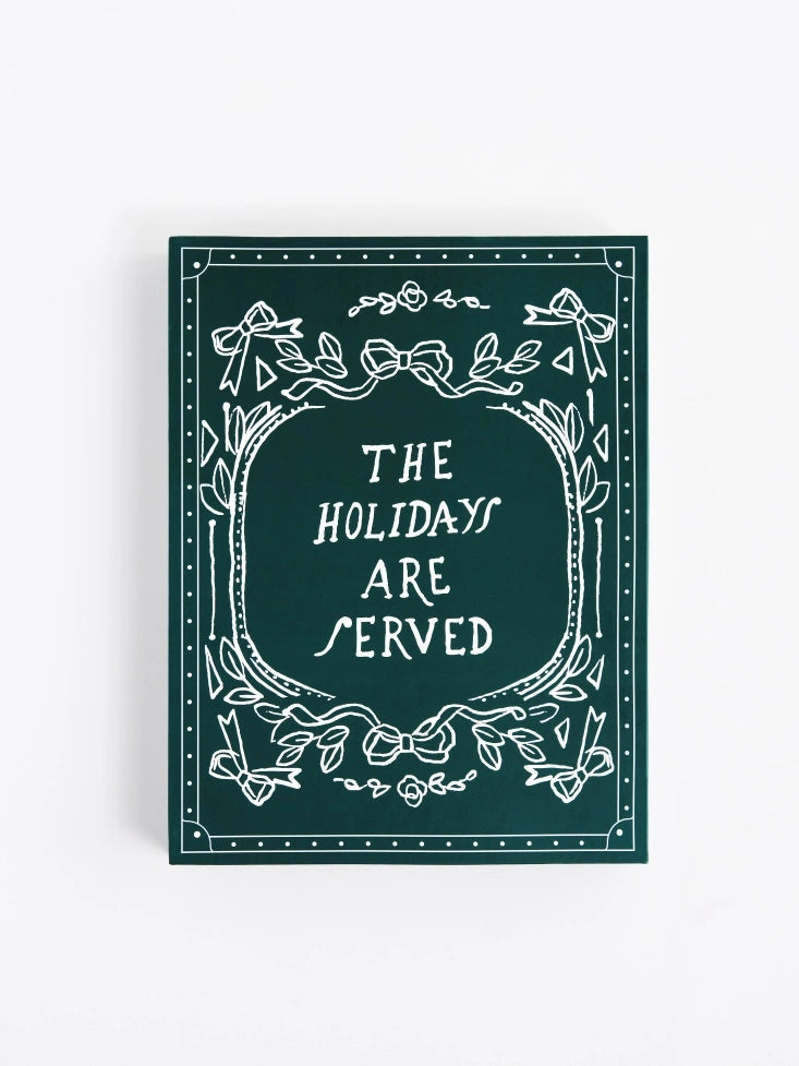 Four Seasons chocolate holiday calendar packaging on a white background with the quote "The Holidays are served"