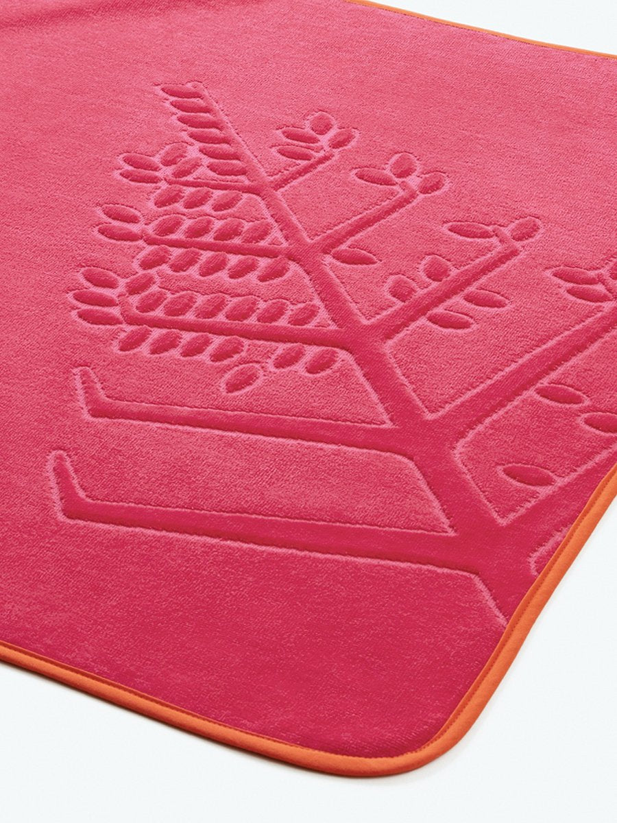 Close-up of a "Coral Reef Pink" hooded baby towel with an embroidered Four Seasons logo. - {{Coral Reef Pink / Mountain Grey}}