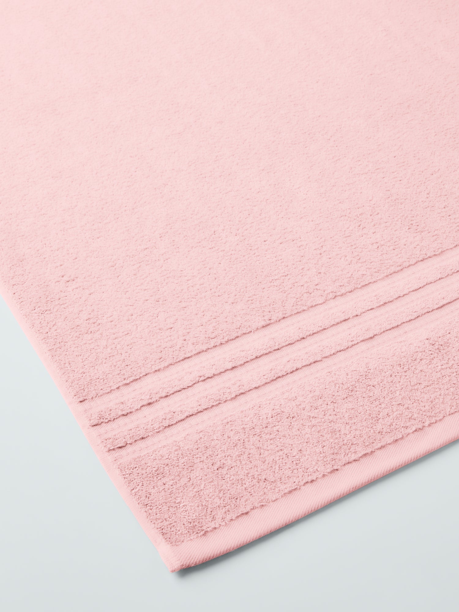 plush, folded bath sheets in a warm, inviting "Kyoto Blush" color. The towels have a thick, textured weave and subtle stripes - {{Kyoto Blush}}
