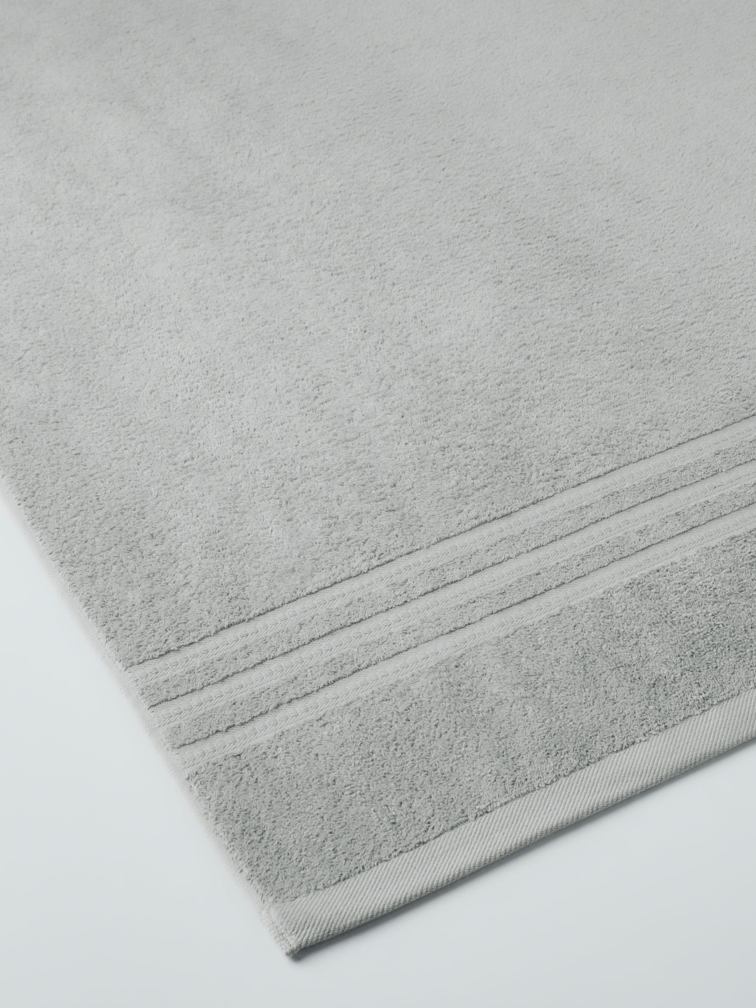 plush, folded bath sheets in a warm, inviting "Spanish Slate" color. The towels have a thick, textured weave and subtle stripes - {{Spanish Slate}}