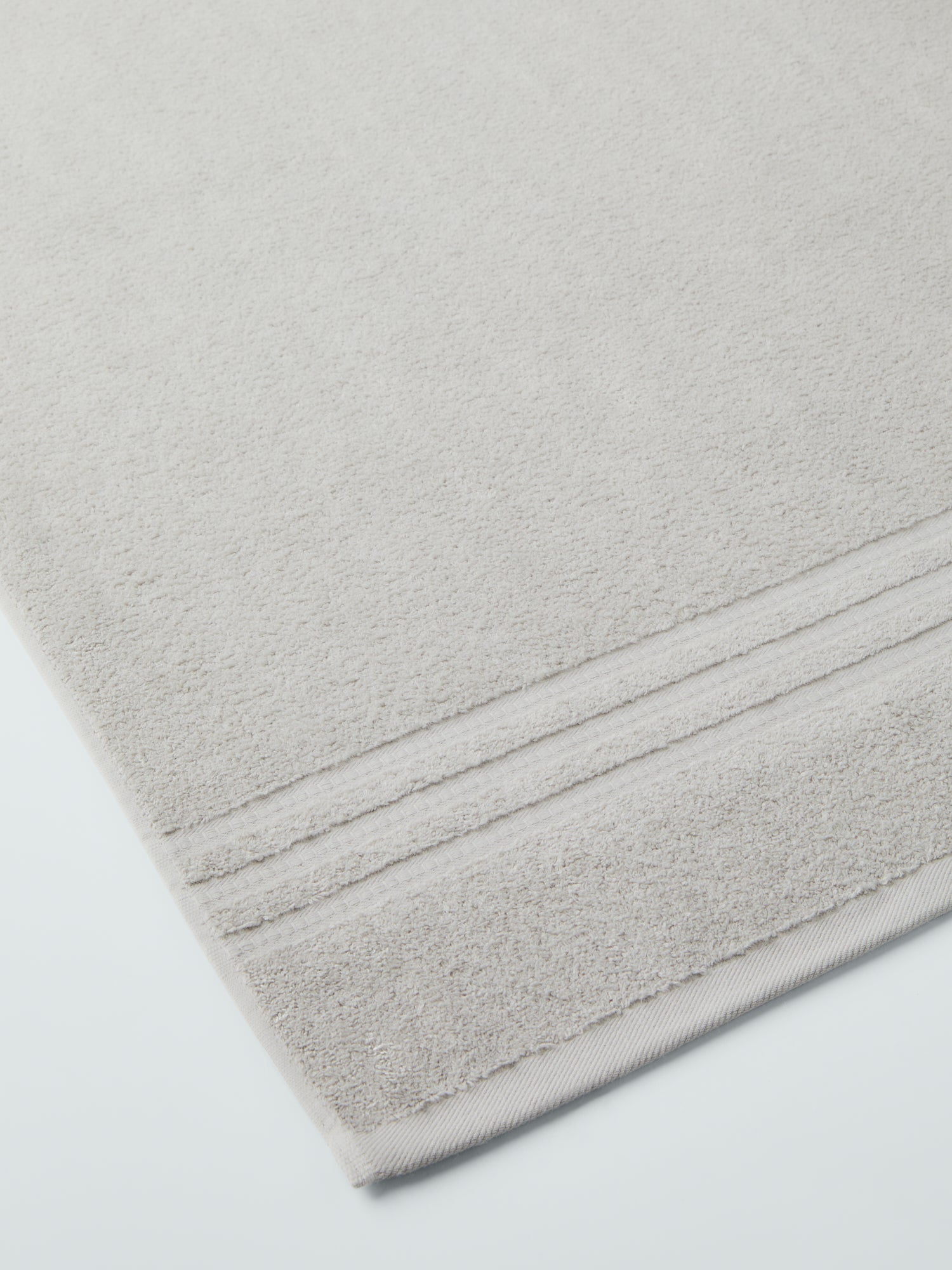 plush, folded bath sheets in a warm, inviting "Turkish Silver" color. The towels have a thick, textured weave and subtle stripes - {{Turkish Silver}}