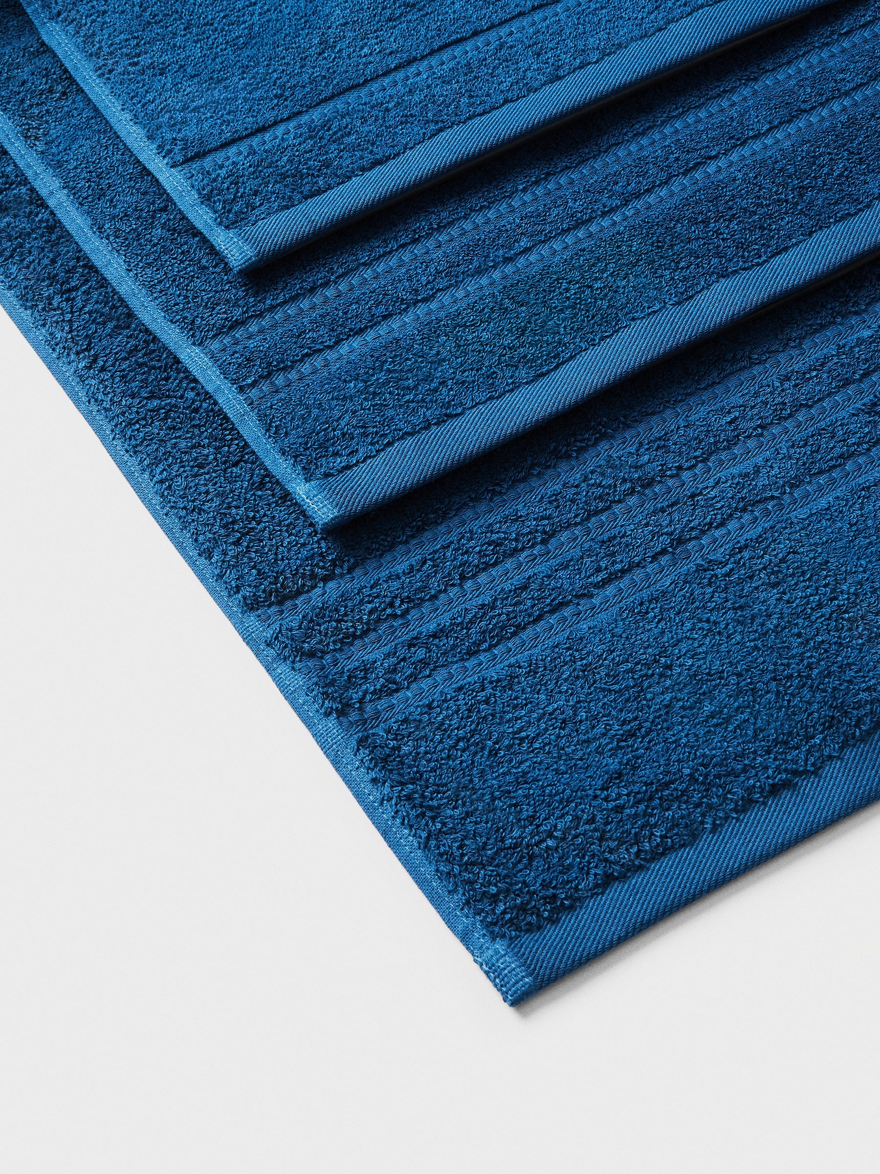 towel set in Riviera Navy, finished with a patterned dobby border. - {{Riviera Navy}}