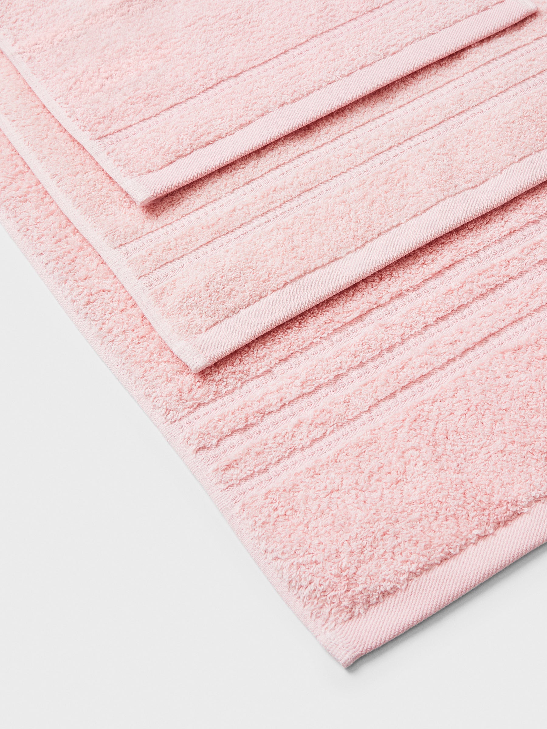 towel set in Kyoto Blush, finished with a patterned dobby border. - {{Kyoto Blush}}