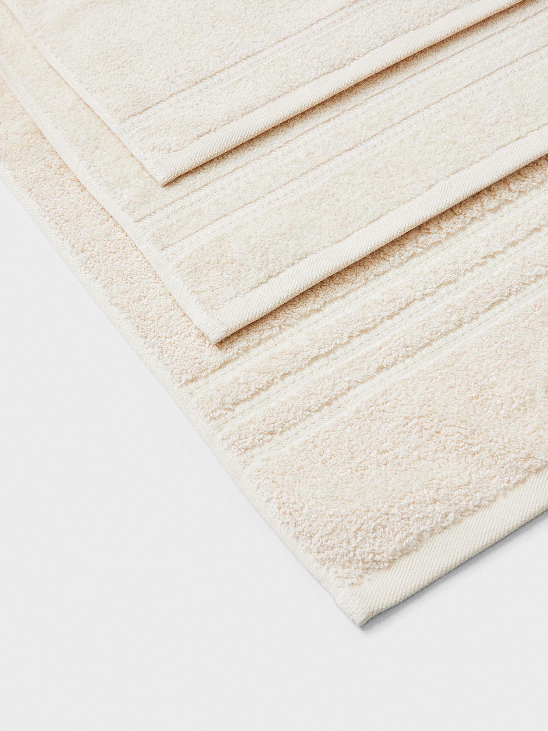 towel set in Balinese Pearl, finished with a patterned dobby border. - {{Balinese Pearl}}