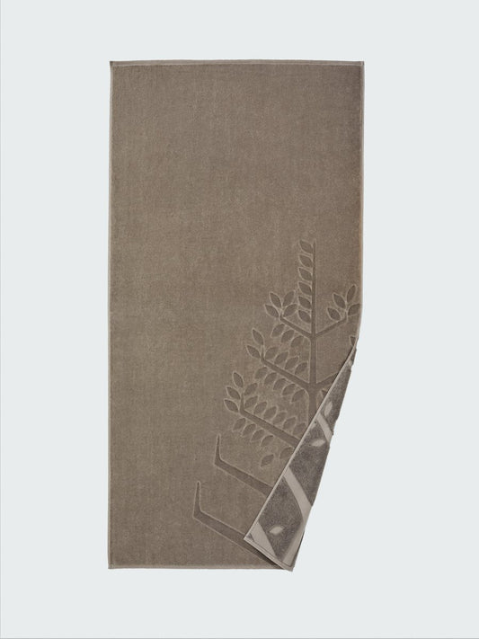 "California Driftwood" beach towel with an embossed Four Seasons logo. Part of the towel is folded back to reveal the same design on the bottom. - {{Californian Driftwood}}