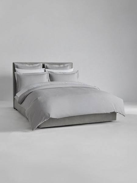 Luxury bed dressed with Turkish Silver/Signature White sheets and duvet.