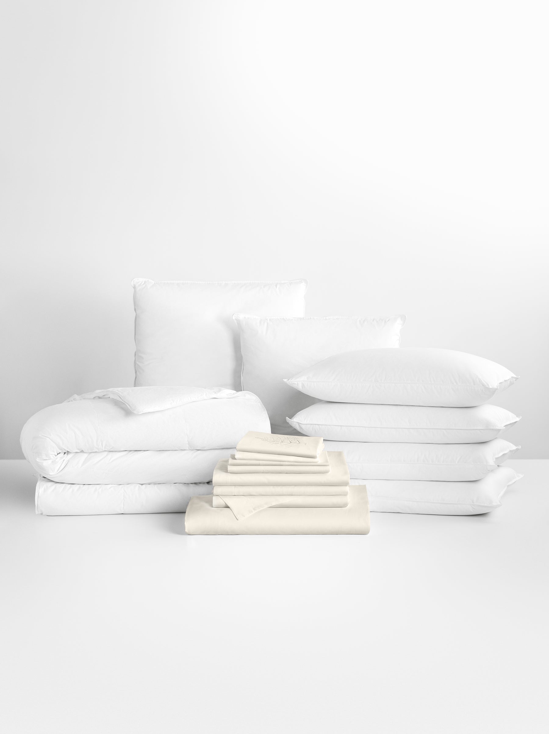 Complete bedding set in white tones, including sheets, pillowcases and duvet.