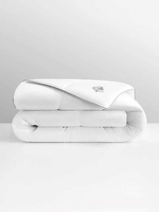 Folded white duvet with a Four Seasons logo on a light gray background.