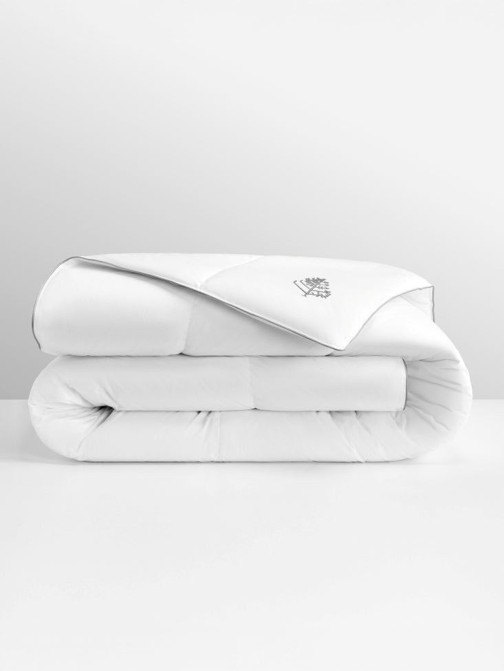 White pure down duvet folded with a Four Seasons logo on a light gray background.