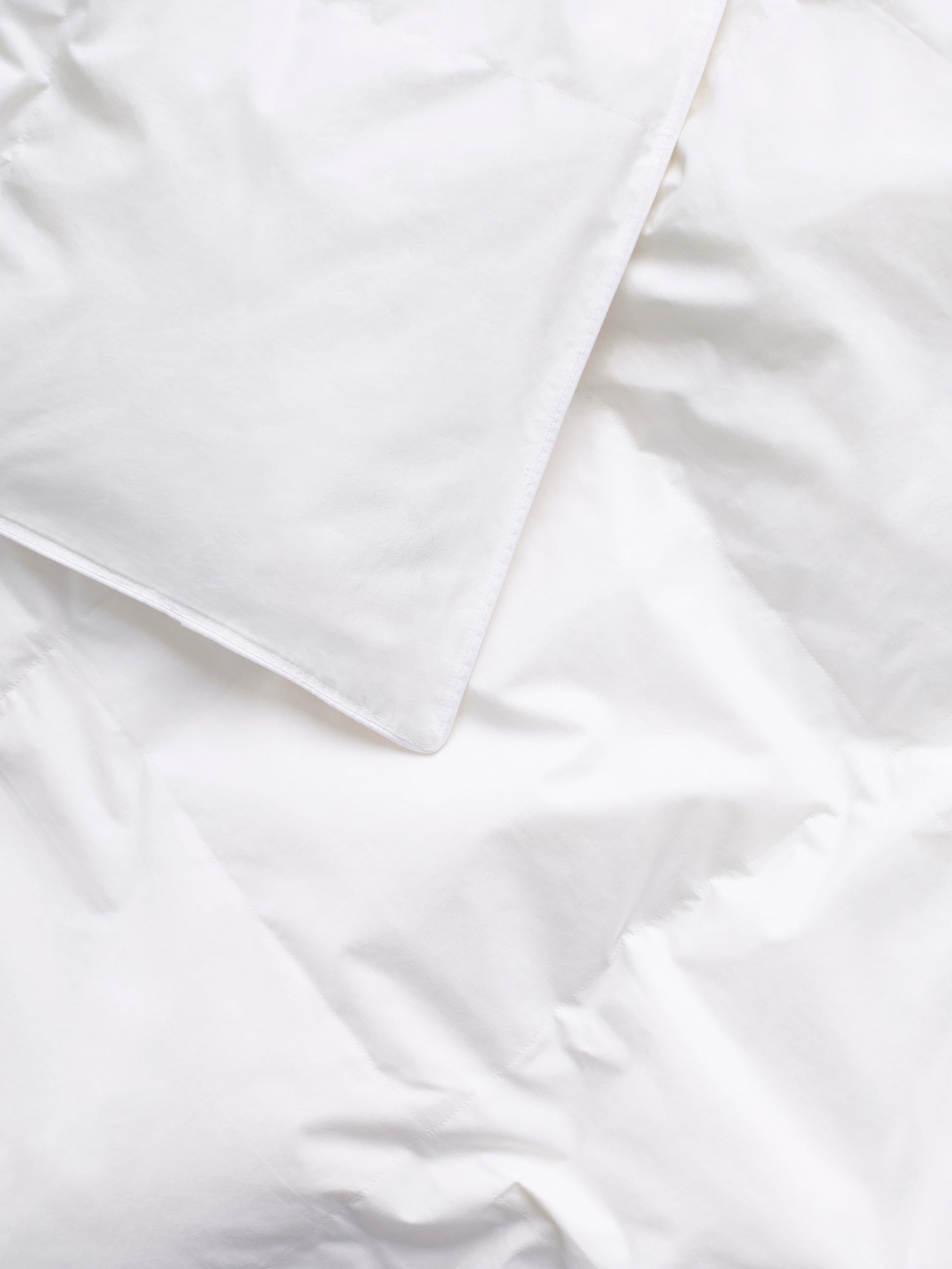 Close-up of a white duvet with a soft and uniform texture