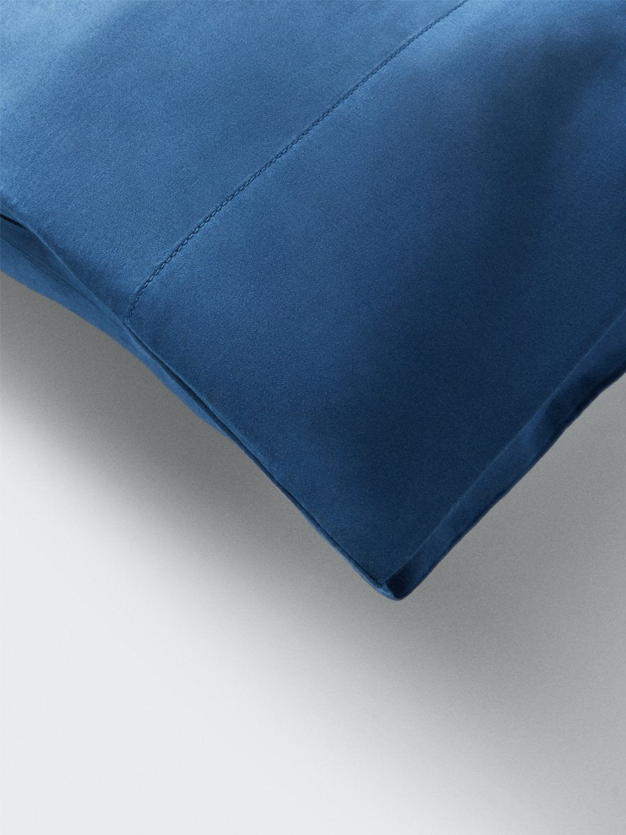 Part of a pillow with a pillowcase in Riviera Navy color. - {{Riviera Navy}}