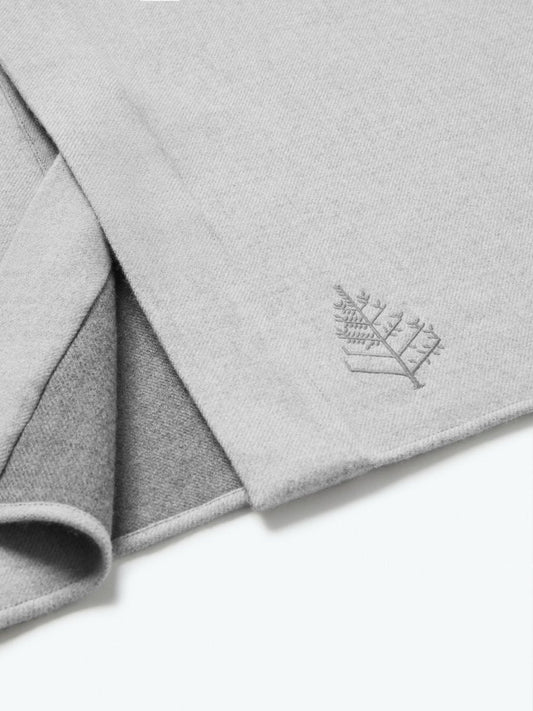 The exterior of the robe showcases a soft and uniform gray tone, while the interior lining is white, creating a pleasing visual contrast. - {{Singapore Mist}}