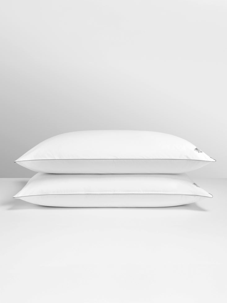 Two pure down pillows stacked on a light gray background.
