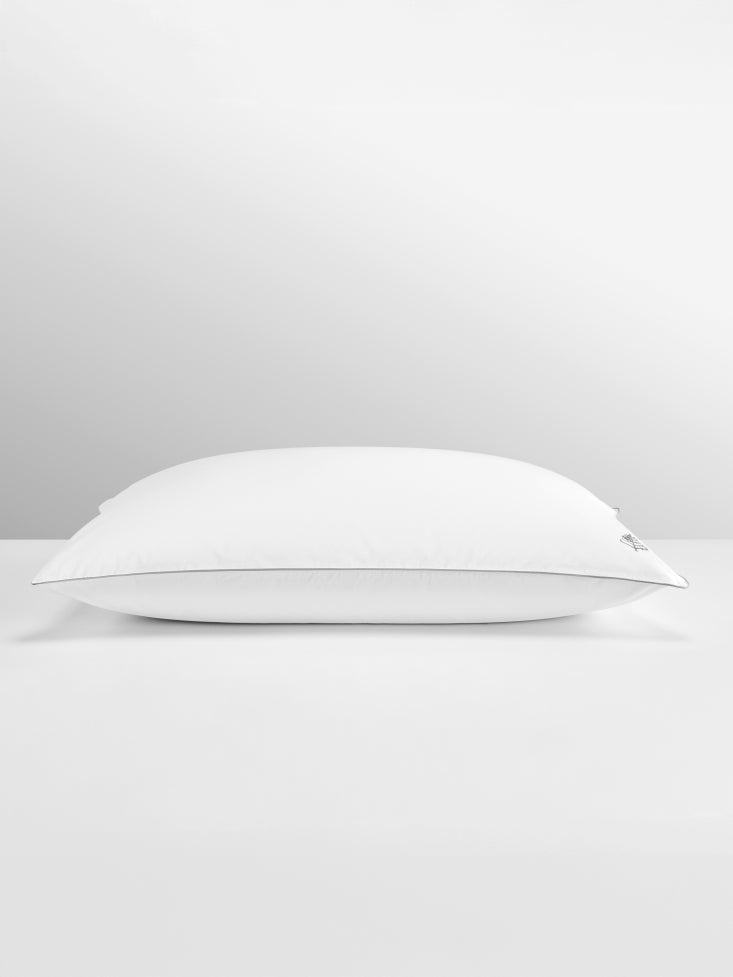 Pure down pillow flatlay image on a grey background.