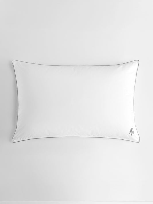 White pure down pillow on a light gray background with grey piping on the seam and a Four Seasons Logo on the bottom right corner.