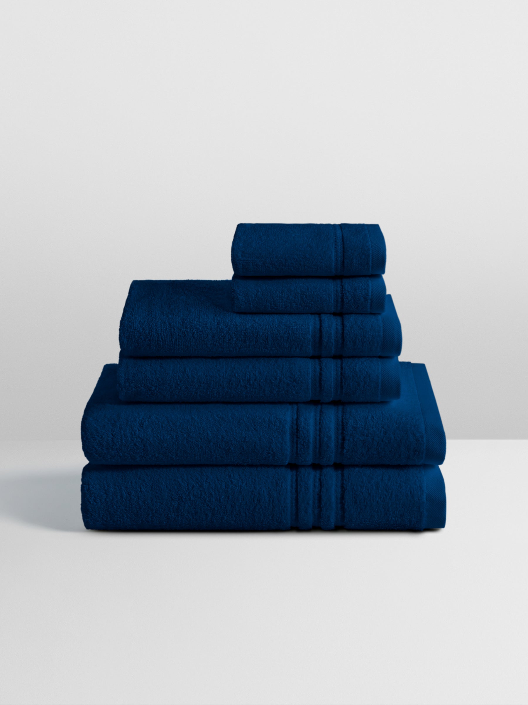 6-piece colored towel set in Riviera Navy, finished with a patterned dobby border.