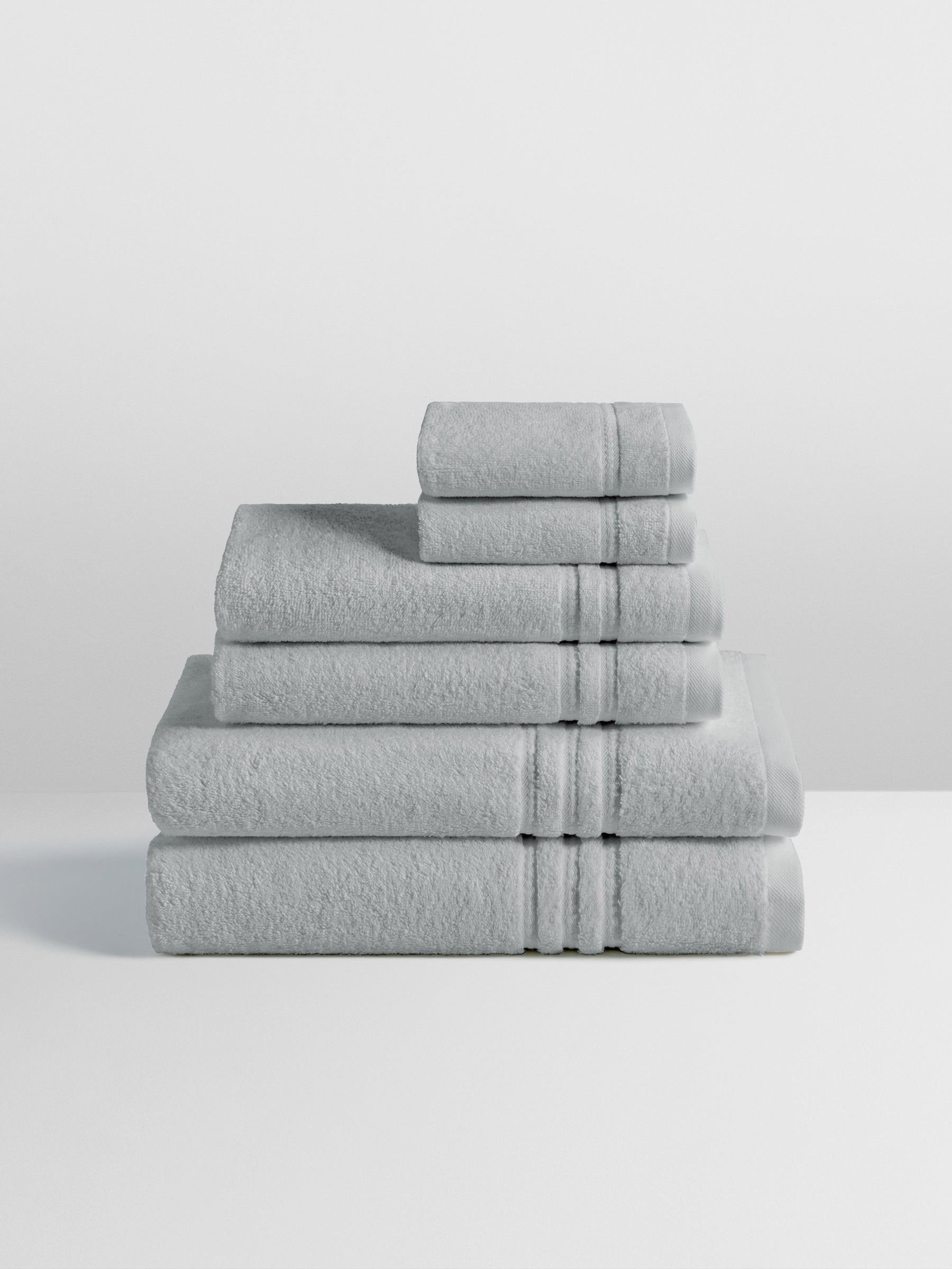 6-piece colored towel set in Spanish Slate, finished with a patterned dobby border. - {{Spanish Slate}}