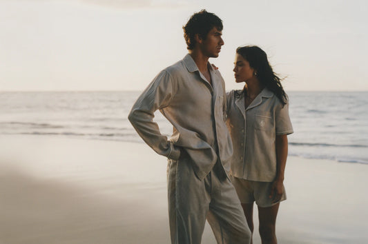 Two people standing on a beach wearing Four Seasons pajama sets.