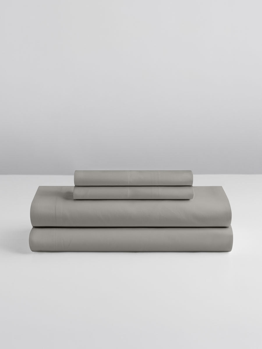 A set of Spanish Slate-colored sheets, folded into perfect rectangles and stacked on a flat surface.