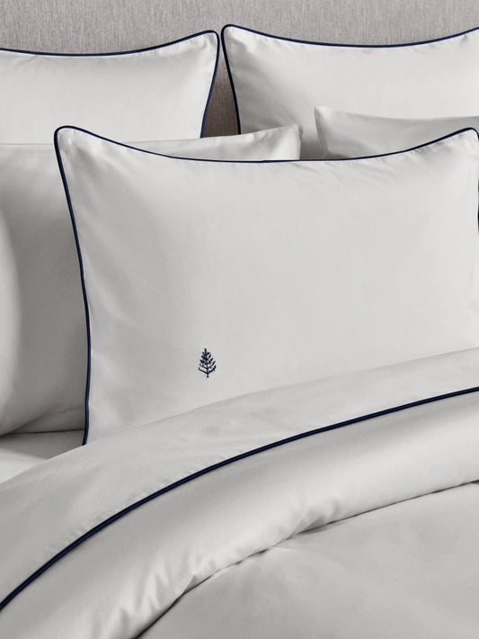 Close-up of bed with Signature White Sycamore duvet and pillows {{Signature White}}