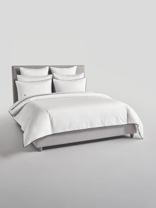 Bed with Signature White Sycamore duvet and pillows {{Signature White}}.