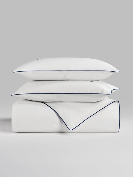 Sycamore Signature White duvet cover set stacked folded duvet and pillowcases. {{Signature White}}