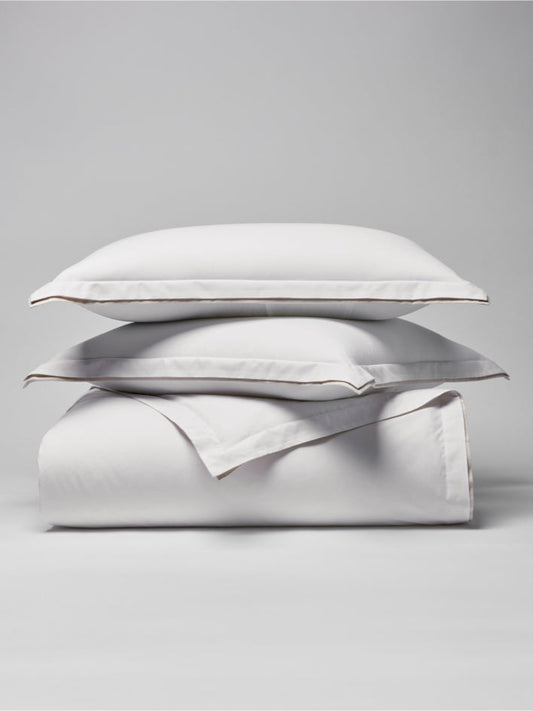 Two pillows carefully placed on top of a sheet. - {{Signature White/Balinese Pearl}}