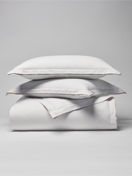 Two pillows carefully placed on top of a sheet.