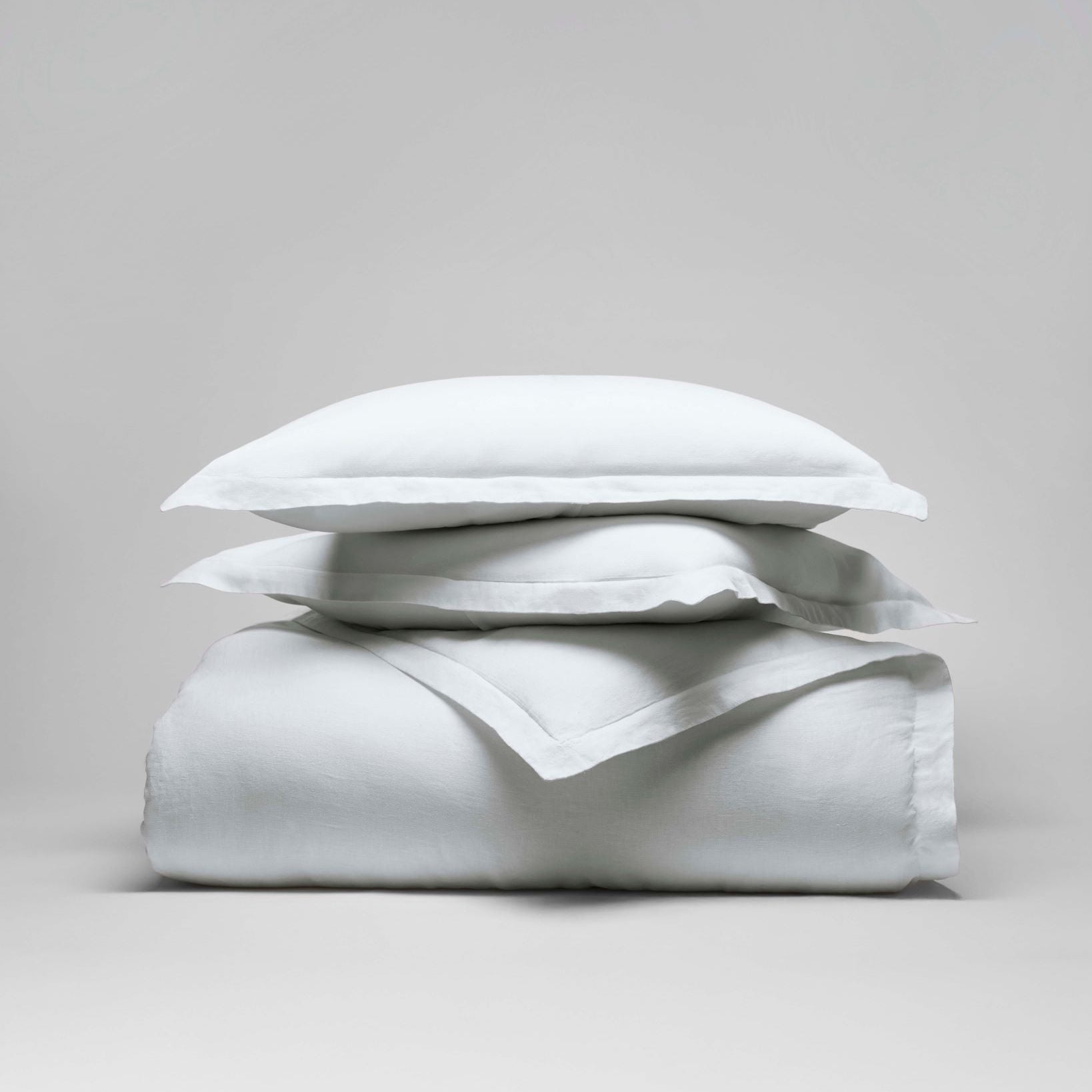 Acacia Duvet Cover Set in Signature White—stacked linen duvet cover with pillow and Euro shams, soft flange edges - {{Signature White}}