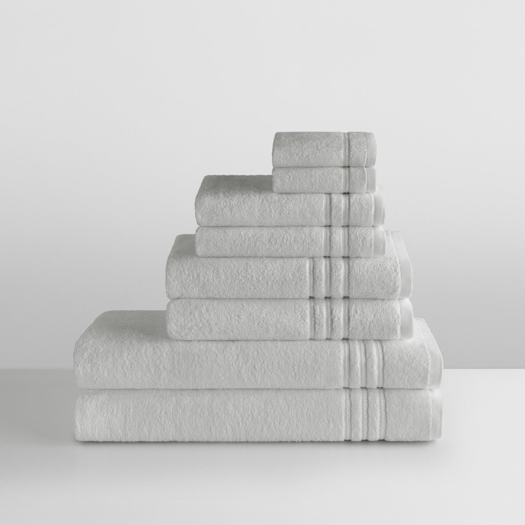 Bath Towel Ensemble in Turkish Silver—stacked 8-piece set showing bath sheets, bath towels, hand towels, and wash cloths with dobby borders. - {{Turkish Silver}}