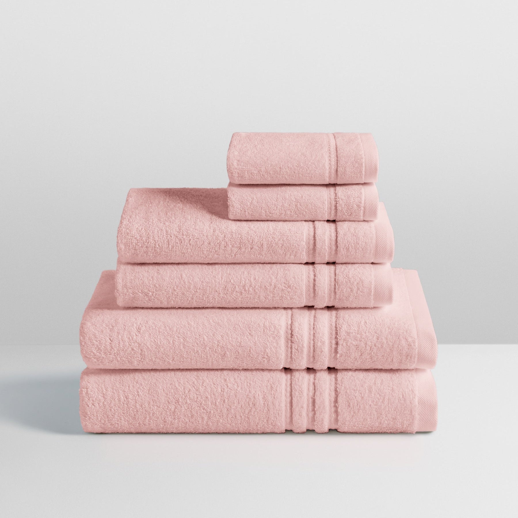 6-piece colored towel set in Kyoto Blush, finished with a patterned dobby border. - {{Kyoto Blush}}