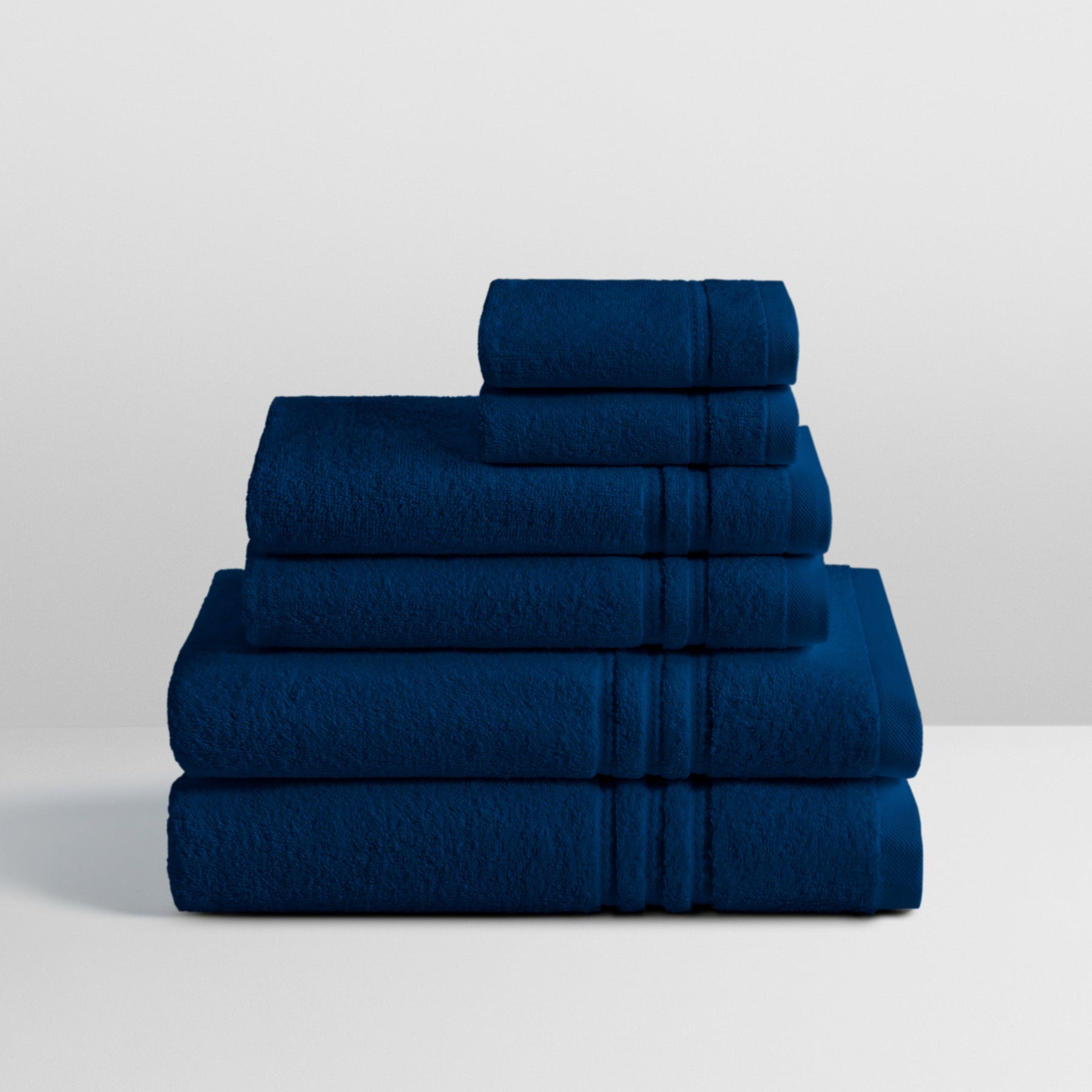 6-piece colored towel set in Riviera Navy, finished with a patterned dobby border. - {{Riviera Navy}}