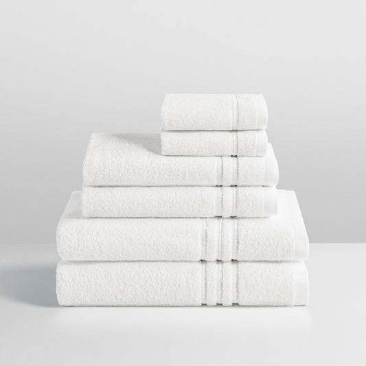 6-piece colored towel set in Signature White, finished with a patterned dobby border. - {{Signature White}}