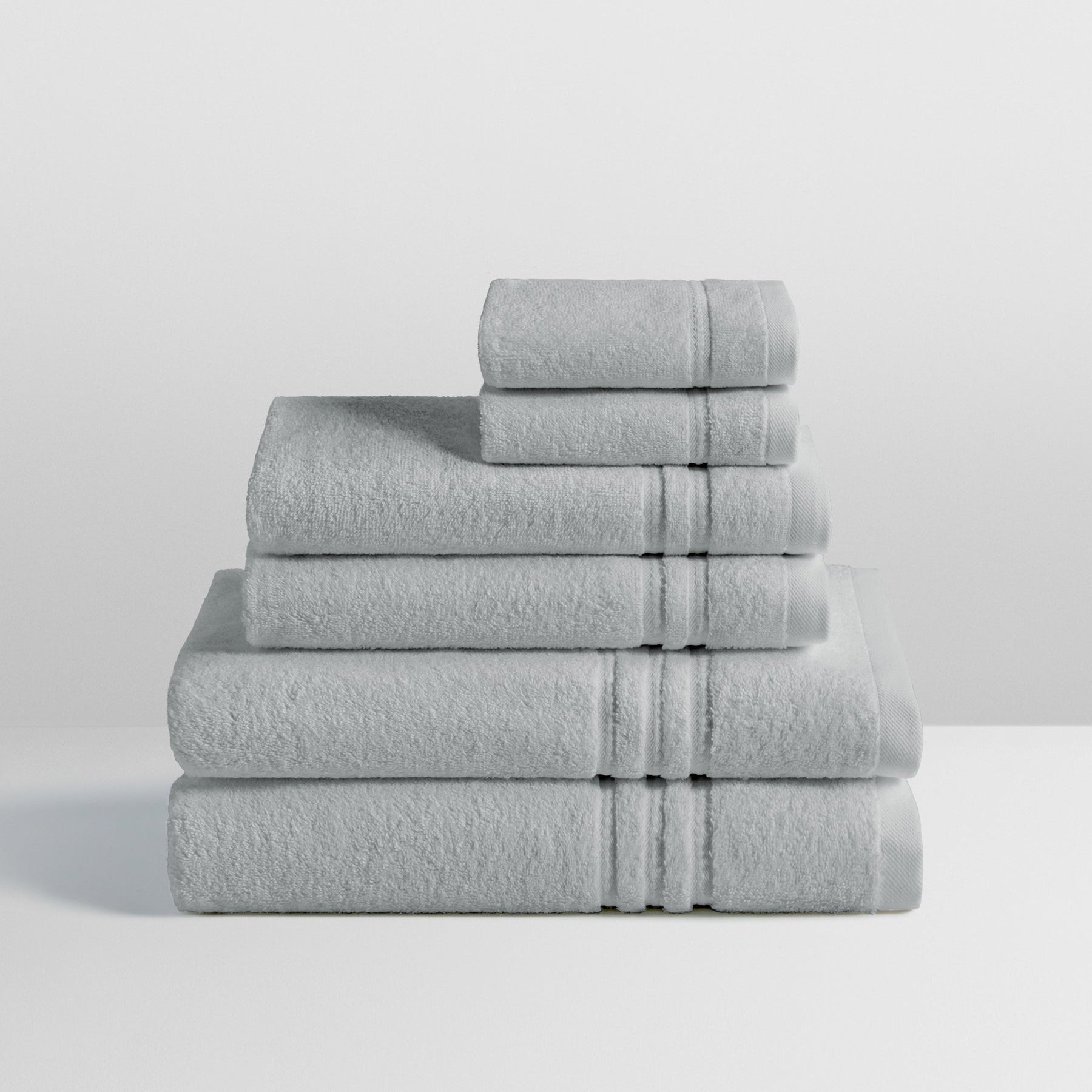 6-piece colored towel set in Spanish Slate, finished with a patterned dobby border. - {{Spanish Slate}}