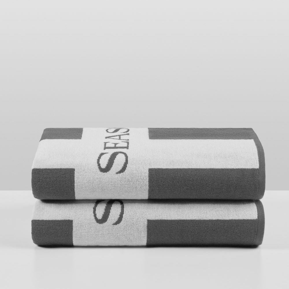 Cabana Pool Towels in Hampshire Charcoal—stacked pair showing bold charcoal-and-white vertical stripes with the woven “Four Seasons” wordmark. {{Hampshire Charcoal}}