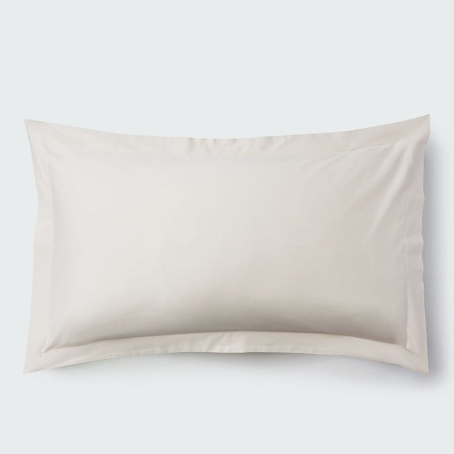 A rectangular pillow with a Balinese Pearl color pillowcase, featuring a delicate embroidery that runs along the entire edge. - {{Balinese Pearl}}