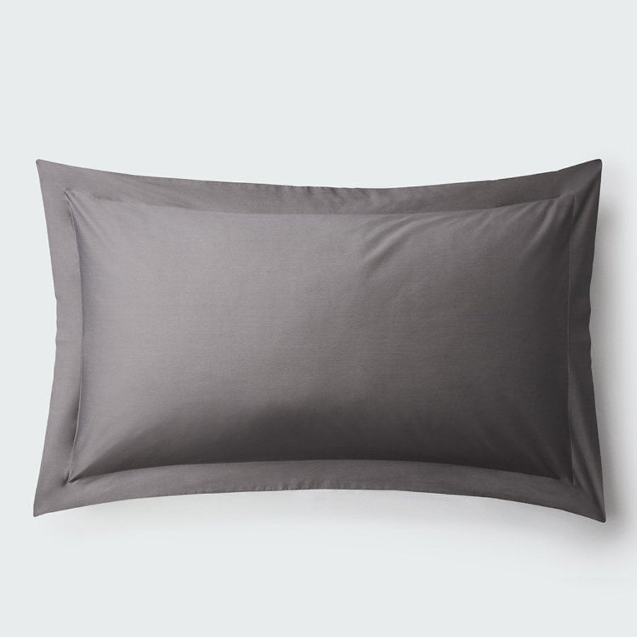 A rectangular pillow with a Hampshire Charcoal color pillowcase, featuring a delicate embroidery that runs along the entire edge. - {{Hampshire Charcoal}}