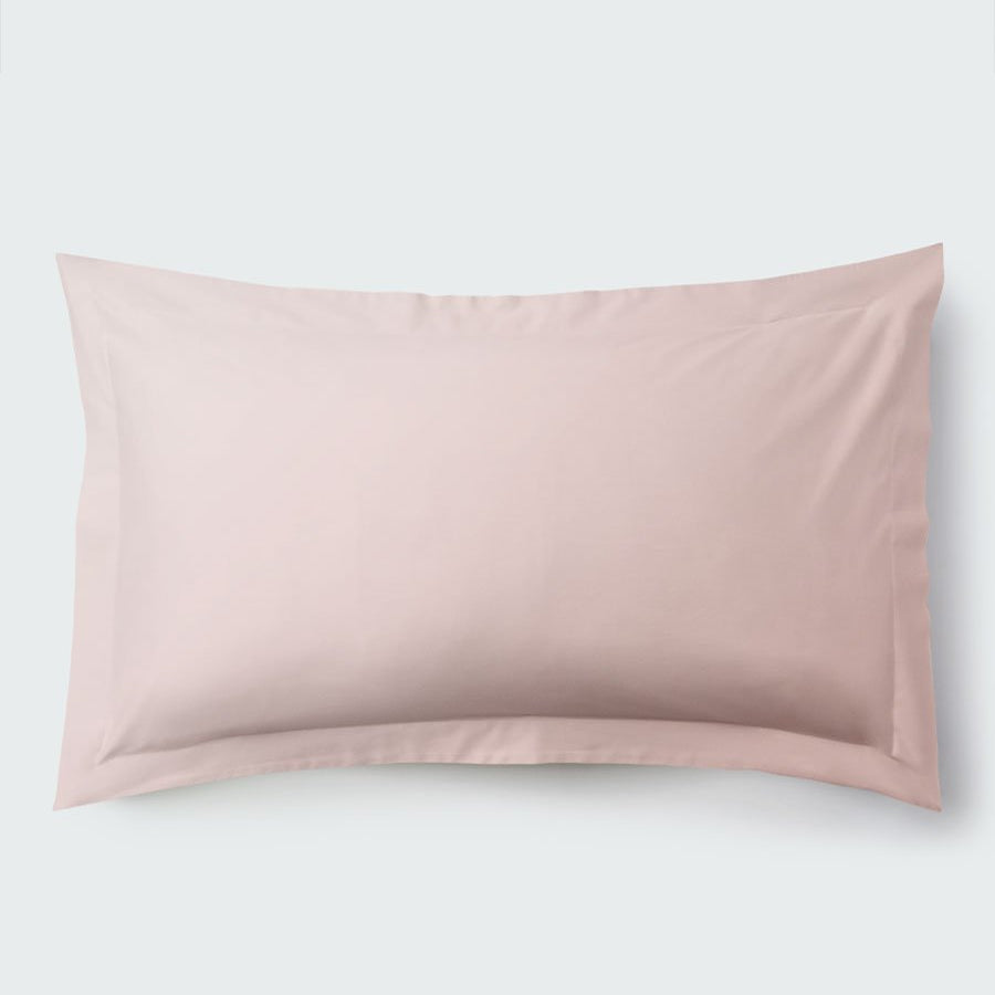 A rectangular pillow with a Kyoto Blush color pillowcase, featuring a delicate embroidery that runs along the entire edge. - {{Kyoto Blush}}