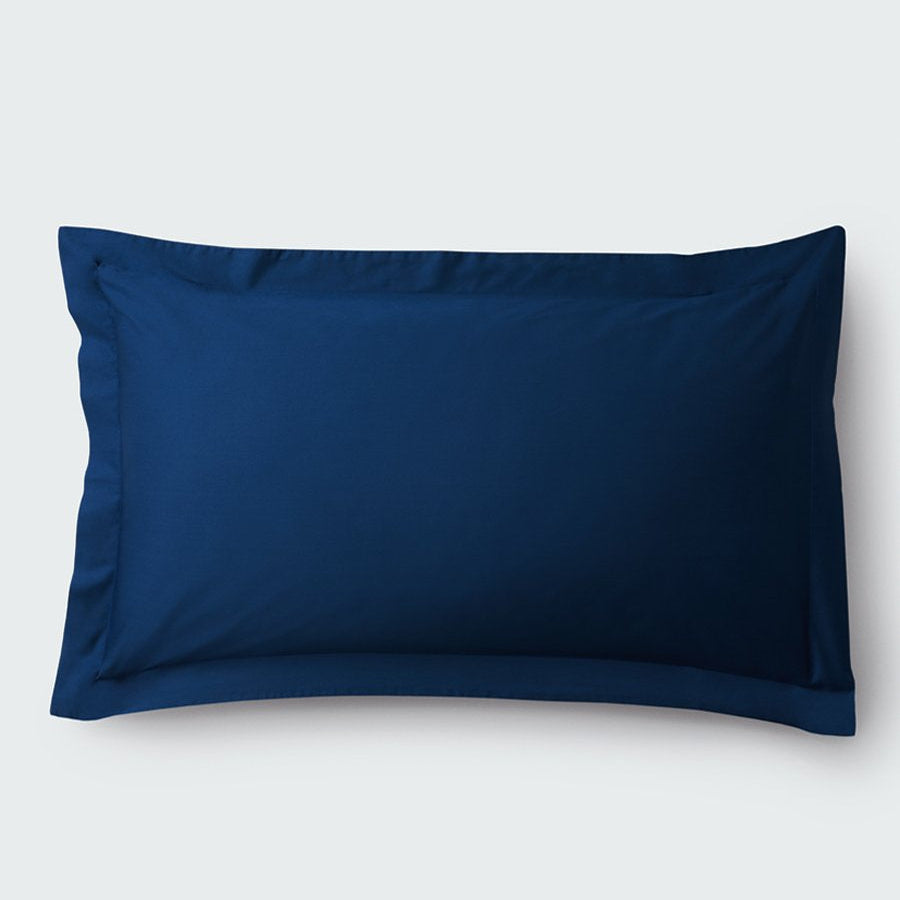 A rectangular pillow with a Riviera Navy color pillowcase, featuring a delicate embroidery that runs along the entire edge. - {{Riviera Navy}}