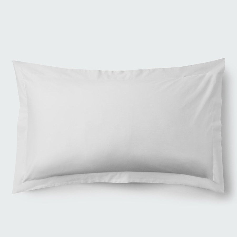 A rectangular pillow with a Signature White color pillowcase, featuring a delicate embroidery that runs along the entire edge. - {{Signature White}}