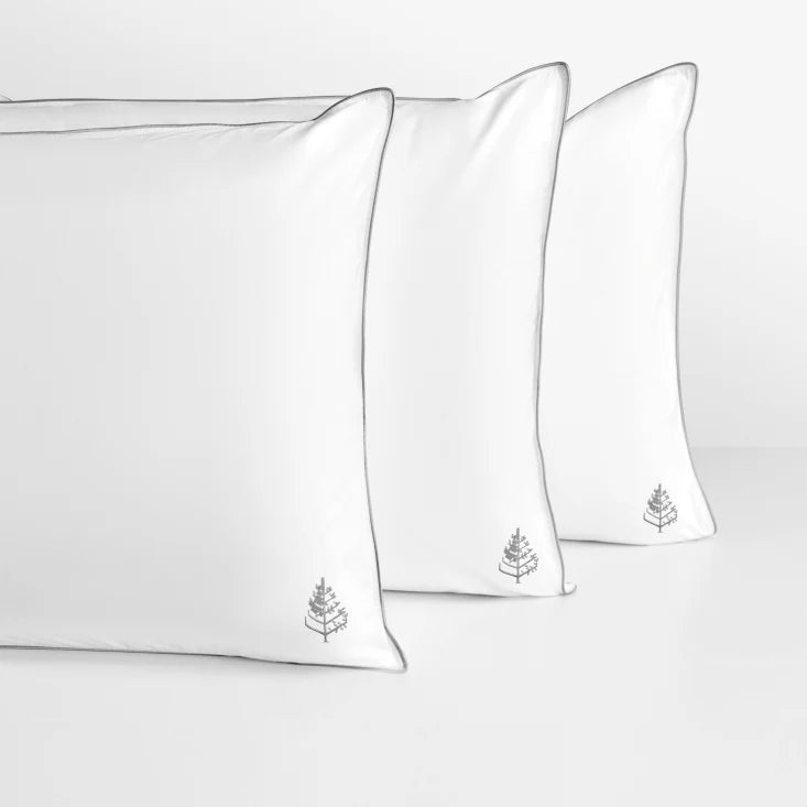 Three white pure down pillows with a small Four Seasons Logo on a light gray background.