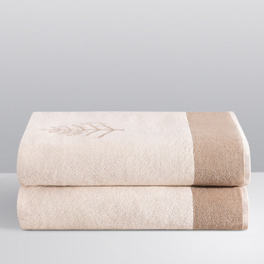 Two folded Resort Towels in a "Californian Driftwood" color, featuring an embroidered Four Seasons logo. The towels are stacked on a white surface. - {{Californian Driftwood}}