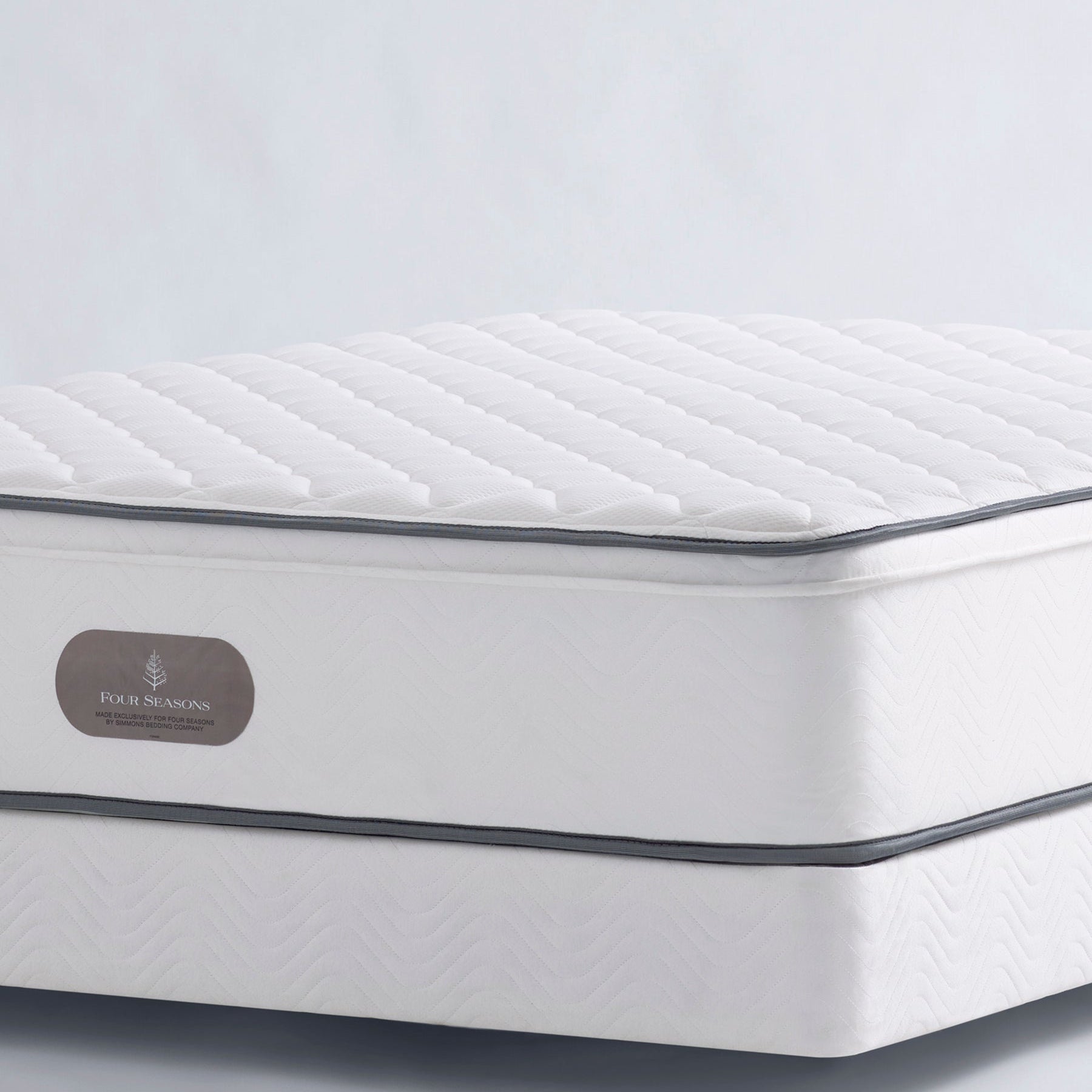 Close-up of the Signature Firm Mattress with quilted sleep surface and contrast edge trim.